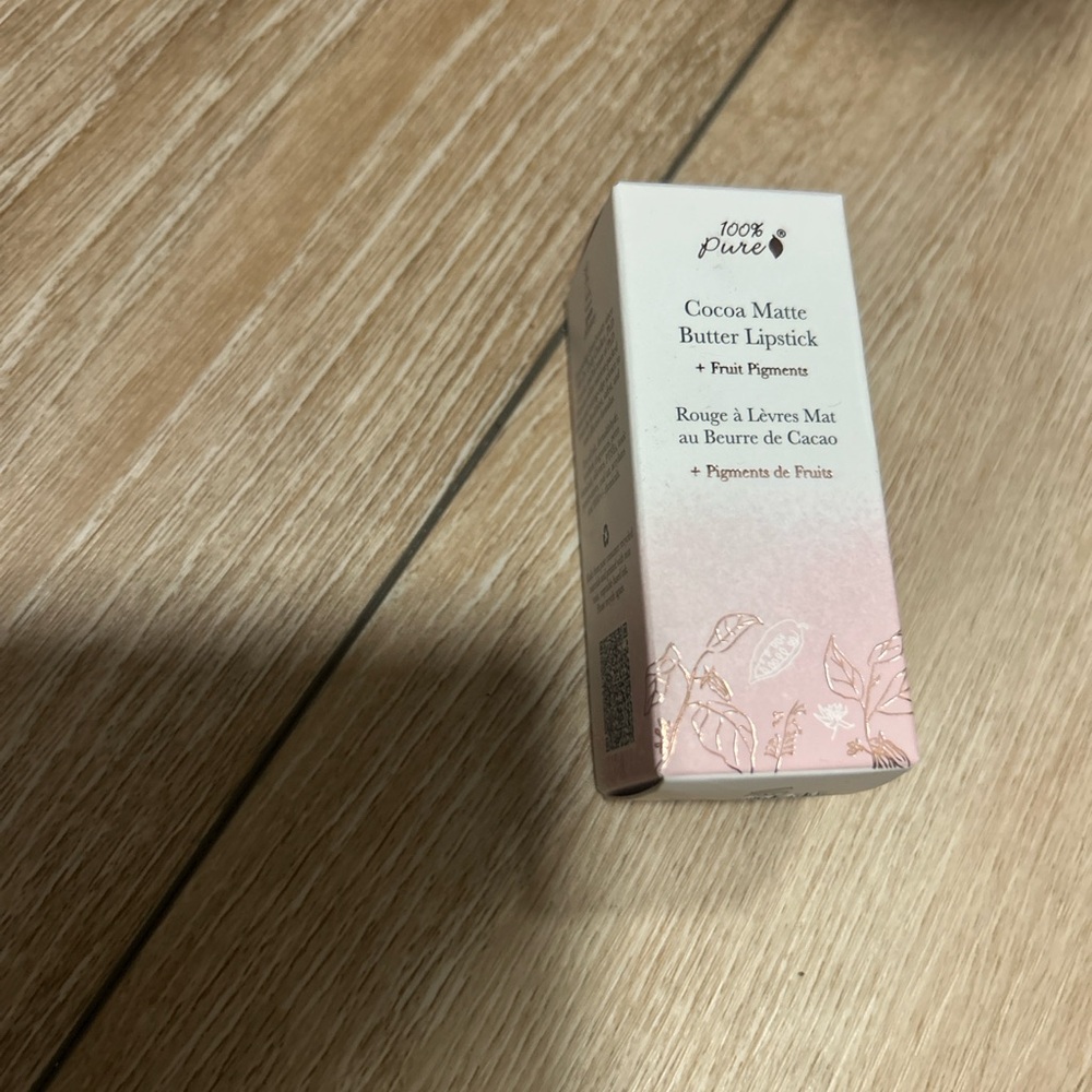 100% Pure Cocoa Matte Lipstick in Plume Pink swiped once in box